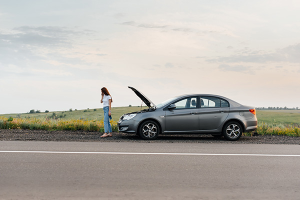 person-by-broken-down-car-a